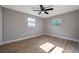 Neutral bedroom offers ample natural light and features wood-look flooring throughout at 3193 Bellevue St, Sarasota, FL 34237