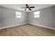 Bright bedroom features wood-look floors and plenty of natural light with two windows at 3193 Bellevue St, Sarasota, FL 34237