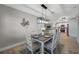 Dining room showcases a modern light fixture and a view into the open-concept kitchen and living spaces at 3193 Bellevue St, Sarasota, FL 34237