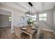 Dining room features a modern light fixture, seating for six, and natural light with an open space design at 3193 Bellevue St, Sarasota, FL 34237