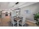 Dining room with modern light fixture and view into the open-concept kitchen and living room at 3193 Bellevue St, Sarasota, FL 34237