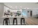 Bright kitchen island with quartz countertops, stainless appliances, and views to the living and dining areas at 3193 Bellevue St, Sarasota, FL 34237