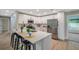 Bright kitchen island with quartz countertops, stainless appliances, and views to the outside at 3193 Bellevue St, Sarasota, FL 34237