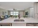 Kitchen island offering a sink, breakfast bar seating, and stainless steel appliances with an open concept to the living room at 3193 Bellevue St, Sarasota, FL 34237
