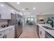 Modern kitchen boasts stainless steel appliances, white cabinetry, and an open layout to dining and living areas at 3193 Bellevue St, Sarasota, FL 34237