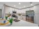 Bright kitchen featuring stainless steel appliances, quartz countertops, and sleek white cabinetry at 3193 Bellevue St, Sarasota, FL 34237