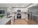 Bright kitchen featuring stainless steel appliances, quartz countertops, and sleek white cabinetry at 3193 Bellevue St, Sarasota, FL 34237