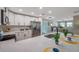 Bright kitchen island with quartz countertops, stainless appliances, and views to the dining area at 3193 Bellevue St, Sarasota, FL 34237