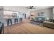 Open-concept living space with modern decor, connecting the kitchen and living area, and featuring hardwood floors at 3193 Bellevue St, Sarasota, FL 34237