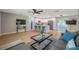 A spacious living area with a modern kitchen, hardwood floors, stylish furniture, and a flat screen television at 3193 Bellevue St, Sarasota, FL 34237