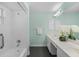 Bright bathroom with a tiled shower, bathtub, double sink vanity, and decorative orchids at 3263 Woodberry Ln # Lot 15, Sarasota, FL 34231