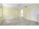 Bedroom with light wood-look floors, neutral walls, and access to an ensuite bathroom at 3263 Woodberry Ln # Lot 15, Sarasota, FL 34231