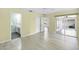 Bedroom boasts neutral paint, wood-look floors, lanai access, and a door to a private bathroom at 3263 Woodberry Ln # Lot 15, Sarasota, FL 34231