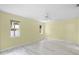 Bedroom with laminate flooring, ceiling fan, and two windows for natural light at 3263 Woodberry Ln # Lot 15, Sarasota, FL 34231