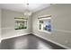 Empty dining room featuring dark tile floors, a chandelier, and two windows at 3263 Woodberry Ln # Lot 15, Sarasota, FL 34231