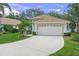 Single-story home with a two-car garage, manicured lawn and landscaping at 3263 Woodberry Ln # Lot 15, Sarasota, FL 34231