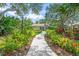 Charming home with a well-manicured lawn and lush landscaping along the walkway at 3263 Woodberry Ln # Lot 15, Sarasota, FL 34231