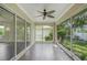 Enclosed lanai features tile floors and ceiling fan with views of the landscaped yard at 3263 Woodberry Ln # Lot 15, Sarasota, FL 34231