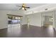 The living room has neutral paint, gray tile flooring, and access to a screened lanai at 3263 Woodberry Ln # Lot 15, Sarasota, FL 34231