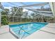 Sparkling pool surrounded by a screened enclosure and ample lounging space at 3263 Woodberry Ln # Lot 15, Sarasota, FL 34231