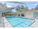 Well-maintained pool with screened enclosure, poolside lounge chairs, and a covered area at 3263 Woodberry Ln # Lot 15, Sarasota, FL 34231