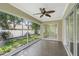 Relaxing screened porch with tile flooring offering an outdoor living space with a beautiful backyard view at 3263 Woodberry Ln # Lot 15, Sarasota, FL 34231