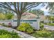 Ashley Oaks community entrance, featuring lush landscaping and an American flag at 3263 Woodberry Ln # Lot 15, Sarasota, FL 34231
