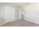 Neutral bedroom features a closet with white paneled doors and carpeted floors at 3303 Pine Top Dr, Valrico, FL 33594