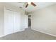 This carpeted bedroom features a closet with white paneled doors and a ceiling fan at 3303 Pine Top Dr, Valrico, FL 33594