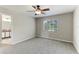 Bedroom featuring neutral carpet, paint, a ceiling fan, and an en-suite bathroom at 3303 Pine Top Dr, Valrico, FL 33594