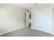 Simple bedroom featuring a closet with white paneled doors and carpeted floors at 3303 Pine Top Dr, Valrico, FL 33594