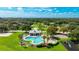 Community pool and amenities, with playground, set among mature trees and lush green spaces at 3303 Pine Top Dr, Valrico, FL 33594