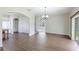 Spacious dining area with hardwood floors, a chandelier, and views into the kitchen and living room at 3303 Pine Top Dr, Valrico, FL 33594