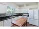 Bright kitchen featuring white cabinets, an island, stainless steel appliances, and a modern backsplash at 3303 Pine Top Dr, Valrico, FL 33594