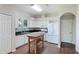 Well-lit kitchen with white cabinets, island, stainless steel appliances, and colorful backsplash at 3303 Pine Top Dr, Valrico, FL 33594