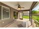 This cozy screened-in patio has great views of the outdoor area and a ceiling fan at 3303 Pine Top Dr, Valrico, FL 33594