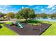 Community playground with slides and swings, cushioned surface, and picnic tables, surrounded by trees at 3303 Pine Top Dr, Valrico, FL 33594