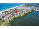 Aerial shot of beachfront condominiums with a sparkling community pool, offering luxurious coastal living at 3540 Gulf Of Mexico Dr # 303, Longboat Key, FL 34228