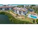 Scenic aerial view of a condo complex with a pool, nestled between the bay and the beach at 3540 Gulf Of Mexico Dr # 303, Longboat Key, FL 34228