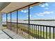 Lovely balcony with a beautiful view of the waterfront and clear blue skies at 3540 Gulf Of Mexico Dr # 303, Longboat Key, FL 34228