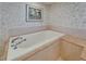 Close up on soaking tub with chrome fixtures and tile surround in Primary bath at 3540 Gulf Of Mexico Dr # 303, Longboat Key, FL 34228