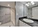 Modern bathroom with a vanity featuring a granite countertop, a white sink, and a shower-tub combination with a white tile surround at 3540 Gulf Of Mexico Dr # 303, Longboat Key, FL 34228