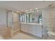 Bright bathroom featuring a walk in shower, double sinks and ample cabinet space at 3540 Gulf Of Mexico Dr # 303, Longboat Key, FL 34228