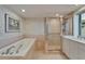 Spacious bathroom with walk-in glass shower and soaking tub at 3540 Gulf Of Mexico Dr # 303, Longboat Key, FL 34228