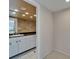 Bathroom with granite countertop, white cabinetry, and recessed lighting, accessed through a doorway at 3540 Gulf Of Mexico Dr # 303, Longboat Key, FL 34228