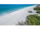 Picturesque aerial view of a pristine white sand beach with turquoise ocean water at 3540 Gulf Of Mexico Dr # 303, Longboat Key, FL 34228