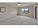 Spacious bedroom with a large window offering scenic views and a ceiling fan providing comfort at 3540 Gulf Of Mexico Dr # 303, Longboat Key, FL 34228