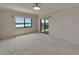 Bright bedroom featuring a ceiling fan, neutral walls, and a sliding glass door leading to a balcony with waterfront views at 3540 Gulf Of Mexico Dr # 303, Longboat Key, FL 34228