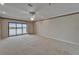 Large bedroom featuring a ceiling fan and sliding doors to the lanai at 3540 Gulf Of Mexico Dr # 303, Longboat Key, FL 34228