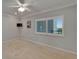 Bright bedroom featuring a ceiling fan, neutral walls, and a window with shutter blinds overlooking a balcony at 3540 Gulf Of Mexico Dr # 303, Longboat Key, FL 34228